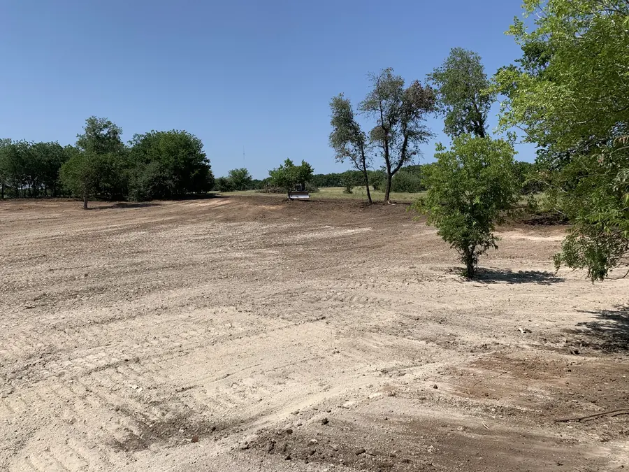 Cleared field with a cluster of trees kept