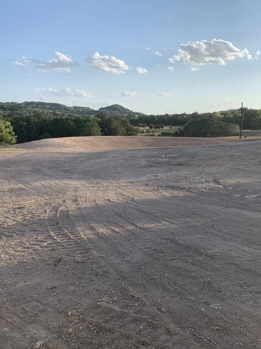 Wide graded pad with hills and clouds behind