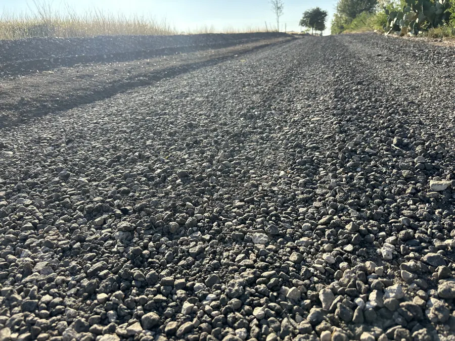 Close view of a fresh dark crushed surface on a drive
